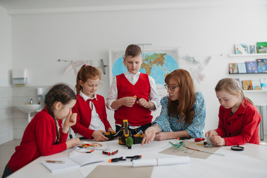Primary school students learning robotics and technology during STEM class.