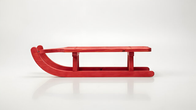A small decorative red wooden sled isolated on white background