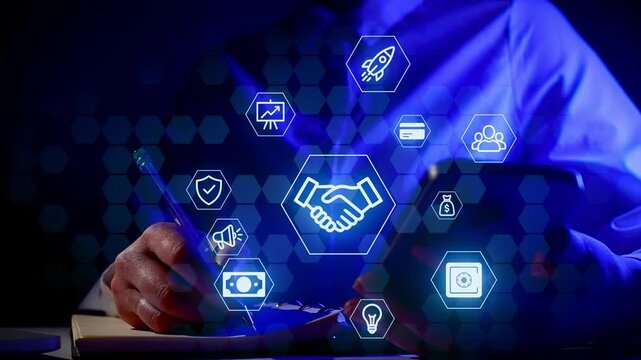 A person is sitting at a desk in a dark space. They are using a phone while writing in a notebook. Various graphics show technology and finance concepts around them.