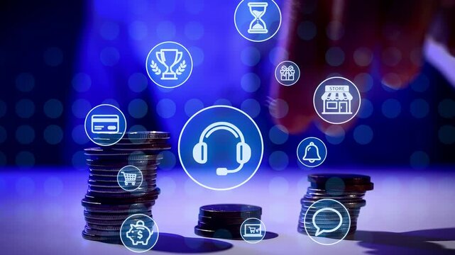 A hand reaches for coins on a table surrounded by digital icons representing various services and activities. The scene shows a mix of finance and technology elements.