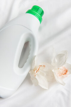 Laundry detergent bottle with orchid on white fabric