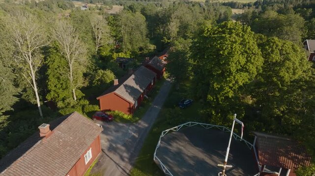 Aerial view of Fagervik steelworks red cottages and maypole dancing pavilion, 4K