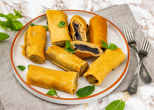 Sweet thin crepe rolls stuffed with poppy seed
