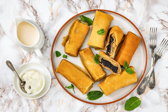 Rolled pancakes with poppy seed filling on plate
