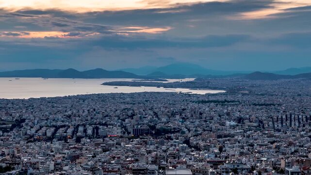 Panoramic day to night timelapse view of the urban skyline of Athens, Greece, with street and ship traffic