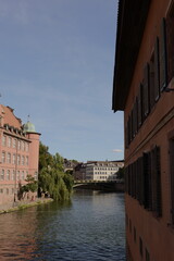 river view of a city square with old buildings and trees © shyl_ui