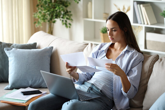 Telecommuter reading letter working at home