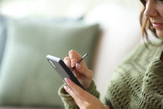 Woman hand handwriting on phone with digital pen at home