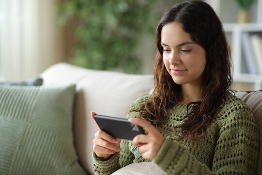 Young woman watching tv or movie on smart phone