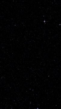 Faint stars glitter across dark night sky. Faint stars shine across dark night sky. Sparse points of starlight remain visible against deep black space creating quiet celestial view.