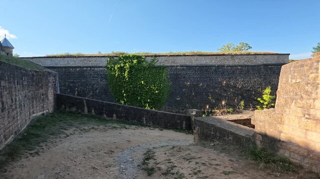 Luxembourg City fortress moat walls in slow panning shot at dusk