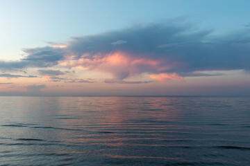 Wide tranquil seascape of the Caspian Sea at dusk, with pastel pink clouds and soft reflections on calm water, minimal horizon and copy space for travel themes © TravelFlow