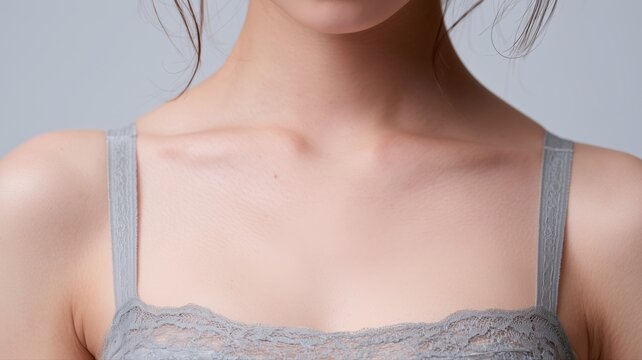 女性の鎖骨と肩が写っている写真。スキンケアや美容関連のイメージに適した素材