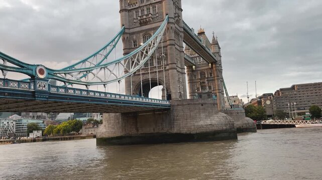 Tower Bridge over River Thames under cloudy sky in London