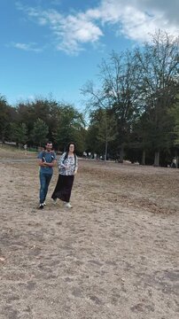 Couple walking together through outdoor park