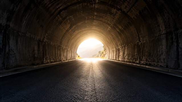Bright tunnel exit with stark contrast and empty road.