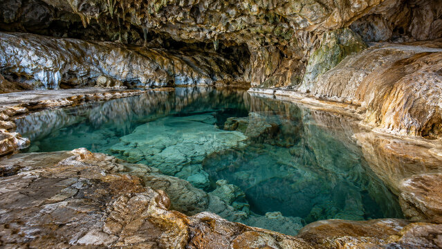 There is still a groundwater pond in a rock cave, and mineral deposits can be seen inside the cave.