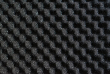 Black protective foam with sharp pyramid peaks, soft packaging material for safe storage and transportation of fragile valuables, shock-absorbing textured surface and industrial lining © Olena Svechkova