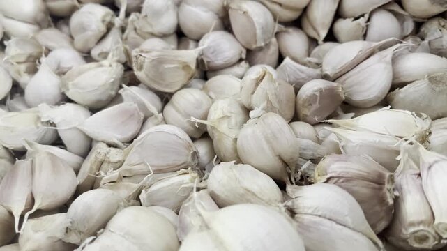 Close up of fresh organic garlic cloves heap background for food concept