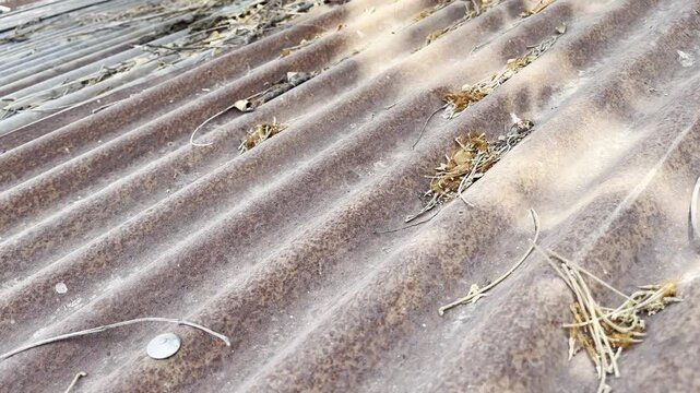 Old rusty corrugated zinc rooftop texture with weathered metal surface
