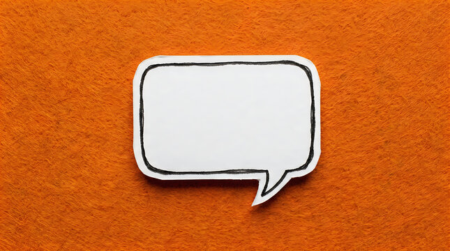 Empty speech bubble cut out from white paper placed on a vibrant orange textured felt background, top view, copy space for text