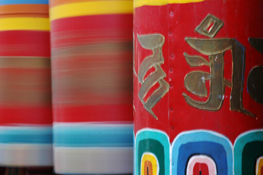 Red Buddhist prayer wheels with golden painted prayers, Paro, Bhutan