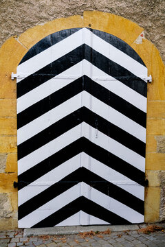 Decorative wooden door with black and white stripes in Germany