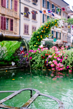 Fountain with flowers in a scenic town square