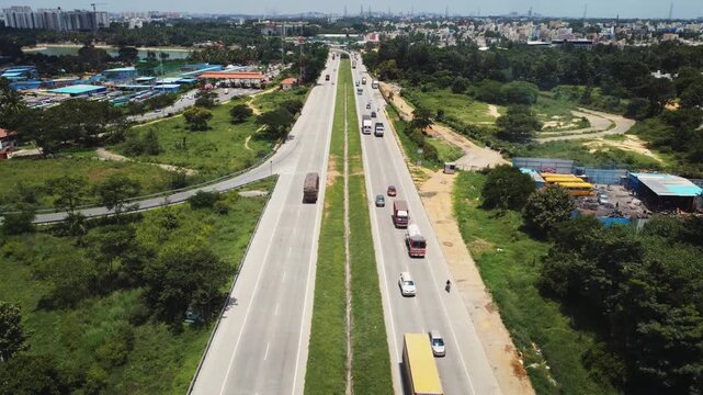 Static 4K aerial view of traffic on the Bengaluru&ndash;Mysuru Expressway in Karnataka, India, showcasing modern highway infrastructure, divided carriageways, and surrounding urban development.