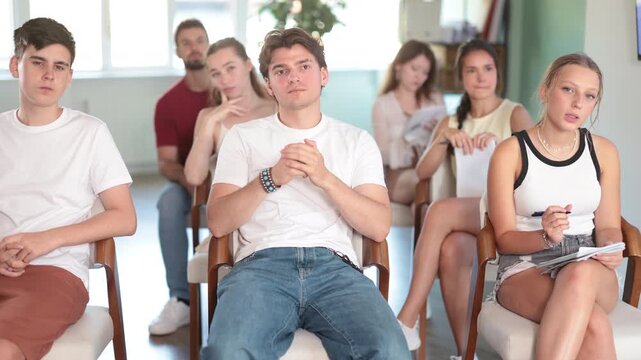At meeting room during lecture, visitors listen to teacher. Lecture on developing own brand, training for startups, personal growth courses, public speaking courses, promotion of healthy lifestyle 