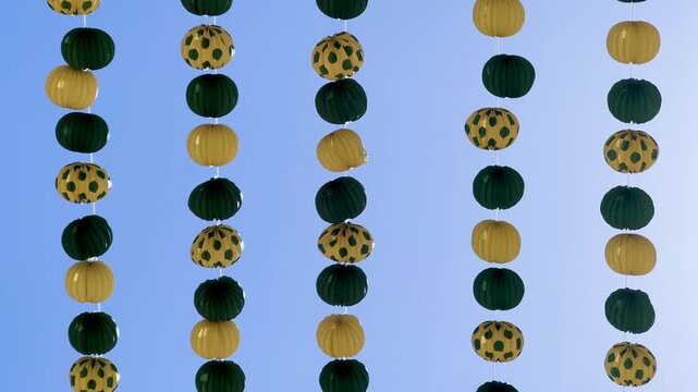 Garlands swinging against a clear blue sky background for autumn seasonal decoration