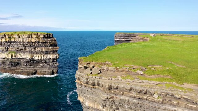 Aerial view of the iconic Dun Briste sea stack rising from the Atlantic Ocean near the rugged cliffs of Ballycastle, County Mayo, Ireland.