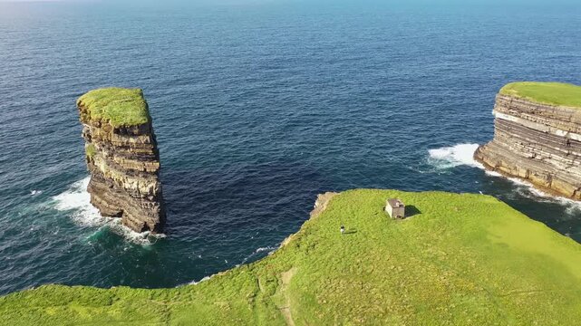 Aerial view of the dramatic Dun Briste sea stack rising from the Atlantic Ocean near the rugged cliffs of Ballycastle, County Mayo, Ireland.