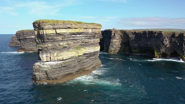 Aerial view of the dramatic Dun Briste Sea Stack rising from the Atlantic Ocean near the rugged cliffs of Ballycastle, County Mayo, Ireland.