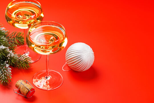 Champagne glasses and snowy fir branches