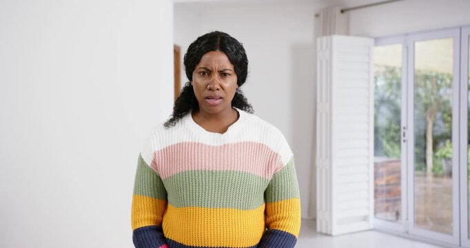 High speed photography for dynamic scenes, looking confused and concerned, woman in colorful sweater