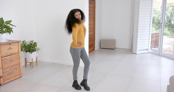 High speed photography for dynamic scenes, woman standing confidently with hands on hips in modern l