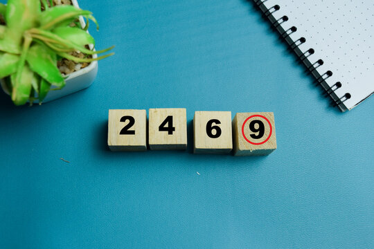 Odd one out logic puzzle with number cubes 2 4 6 and 9 text stacked wooden cubes on the table. For reasoning and problem solving