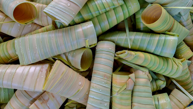 Detailed top view pattern of traditional Bongkol leaf wrappers made from coconut fronds, a signature food wrapper from Bangka Belitung, Indonesia.
