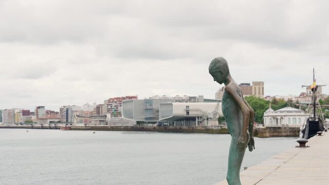 Bronze statues at Monument to the Raqueros on a pier in Santander Spain