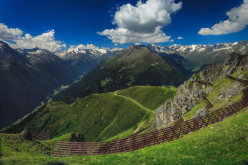 Alpine mountain valley beneath a dramatic sky © Tom Pavlasek