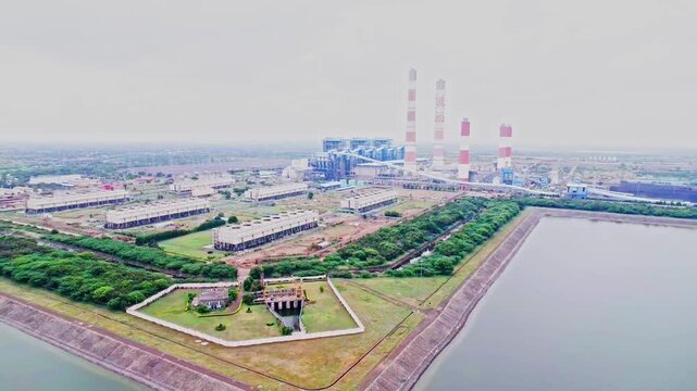 Aerial view of National Thermal Power Corporation with Water Reservoir and smokestack at kudgi, karnataka, india. day time, push back shot, drone shot, 4k.