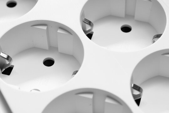 Electric extender. The surge protector background. Closeup of electrical power strip. Power surge. Household surge protector