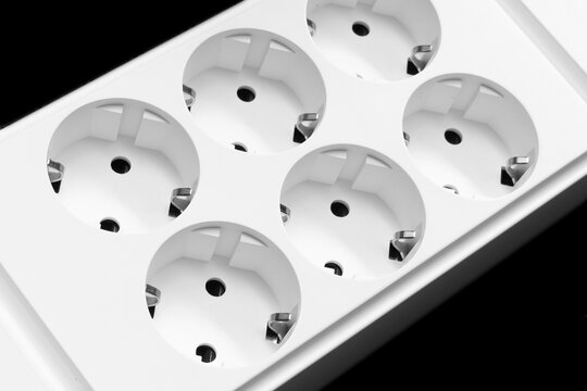 Electric extender. The surge protector background. Closeup of electrical power strip. Power surge. Household surge protector
