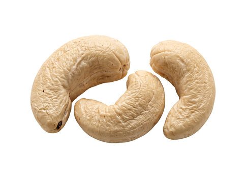 Three raw cashew nuts isolated on black background