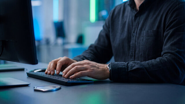 Cybersecurity specialist typing on computer keyboard with metal shield on table, IT security work and data protection concept for network defense, hacker threat and privacy