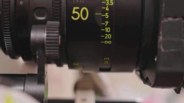 Close-Up of Focus Puller Adjusting 50mm Cinema Lens Distance Scale Rings