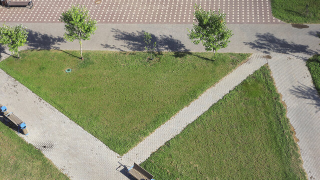 Top-down view of geometric walkways and landscaped lawn represents urban planning, public green space, sustainable infrastructure and municipal landscape design.