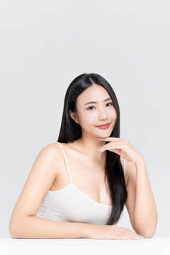 Beautiful young Asian woman with glamour look, glowing face natural makeup and healthy black hair isolated on white background, for advertising about beauty clinic, skincare and cosmetics concept.