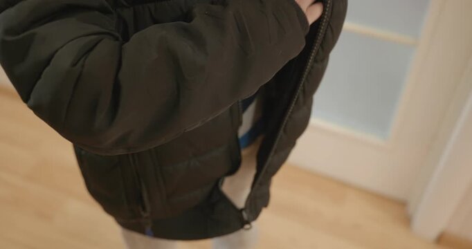 Close-up children's hands zipping zip jacket. 4K 10-bit
